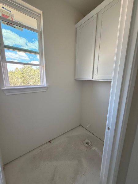 Laundry area featuring concrete floors