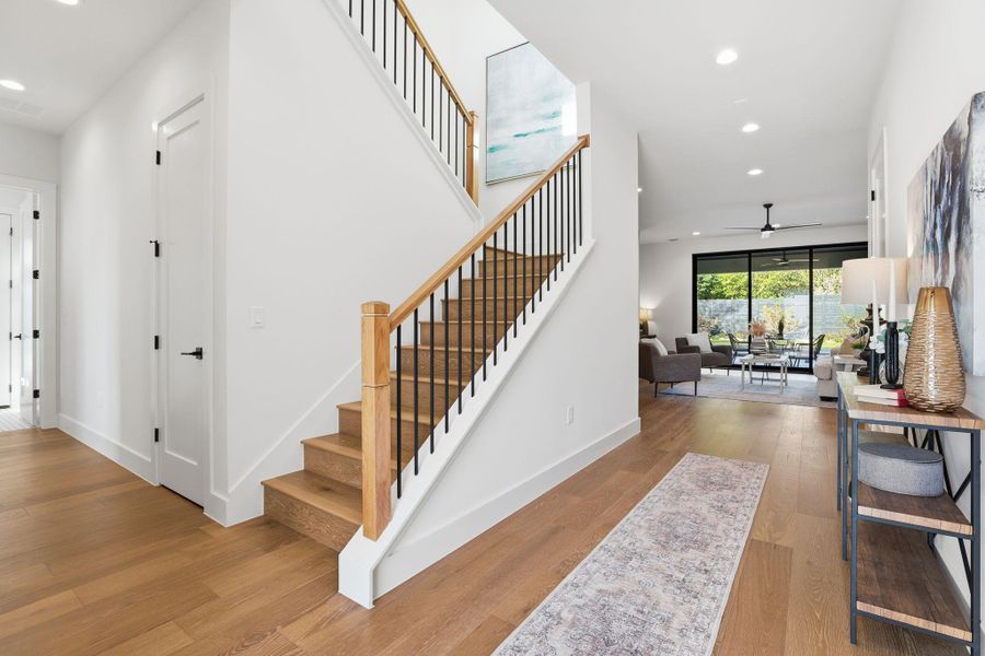 Staircase featuring recessed lighting, wood finished floors, and ceiling fan Staircase featuring recessed lighting, wood finished floors, and ceiling fan