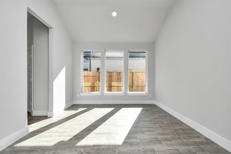 Craft enduring memories with loved ones around the table in this roomy dining area. Boasts stylish flooring, personalized paint, and is conveniently situated next to the family room and kitchen. Oversized windows allowing natural light to pour in! Sample photo of completed home with similar plan. As built color and selections will vary.