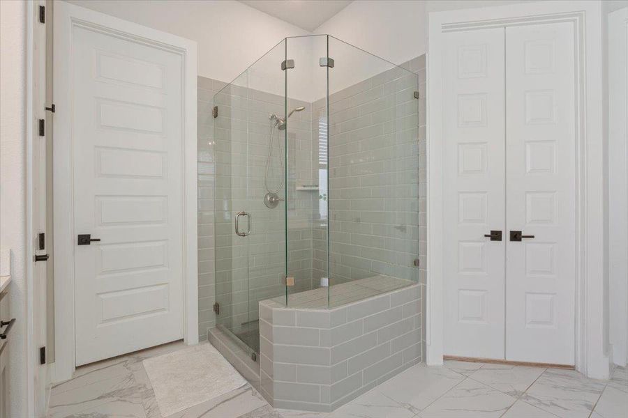 Bathroom with vanity, a stall shower, a closet, and light marble finish floors