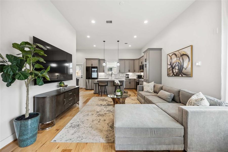 Another view of the open  concept living room and kitchen from the foyer.