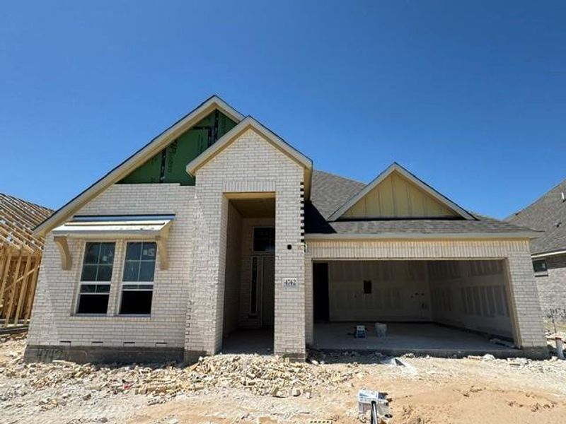A new construction home with brick cladding and an attached garage awaits its finishing touches. A new construction home with brick cladding and an attached garage awaits its finishing touches.