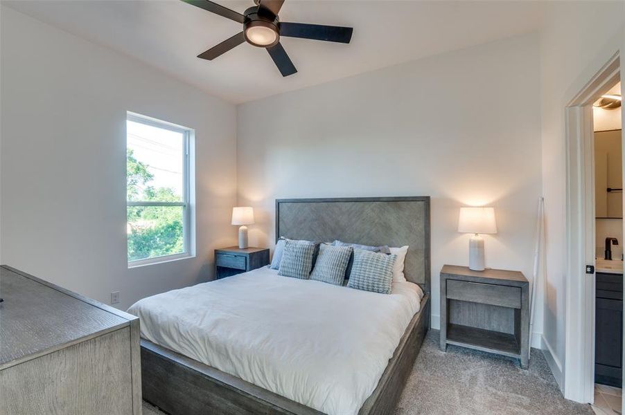 Bedroom featuring light carpet and ceiling fan