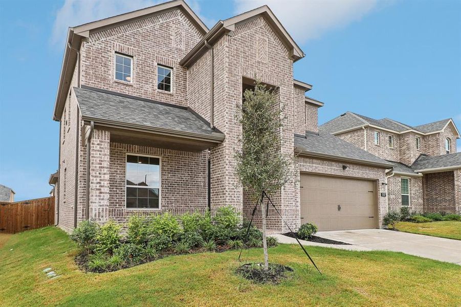 View of front of house with a front yard and a garage