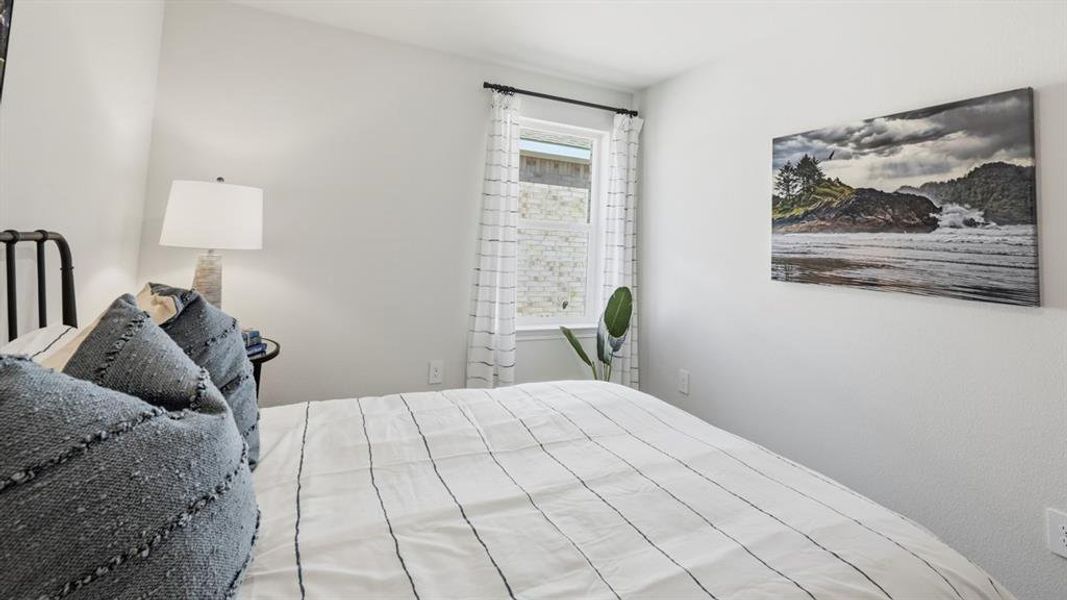 This room features a window with curtains, white walls, and a recessed ceiling light