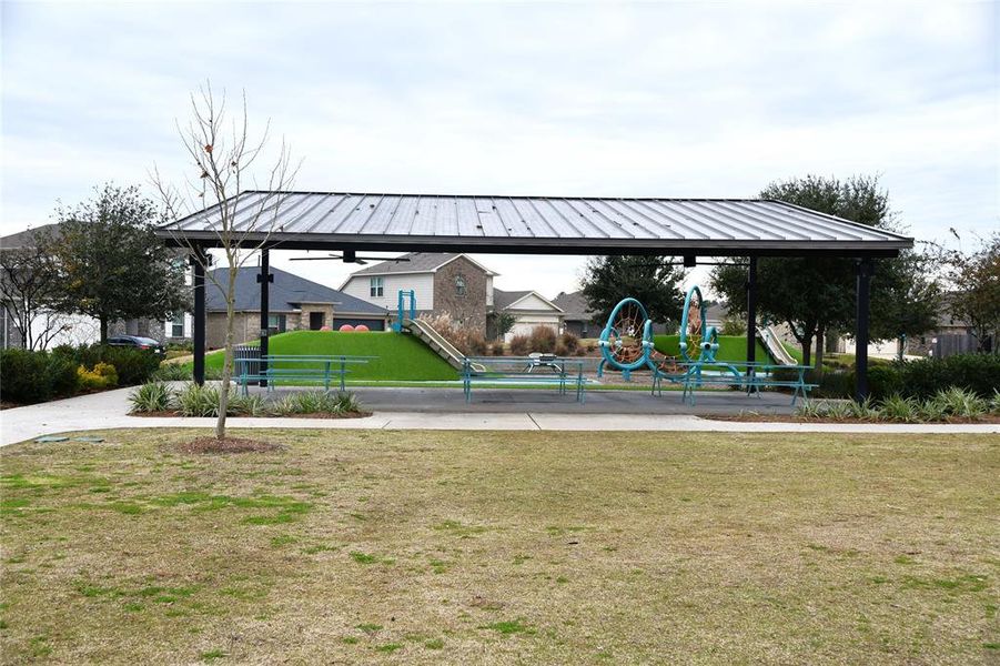 Covered place for parties, picnics, around the playground and the splash pad.