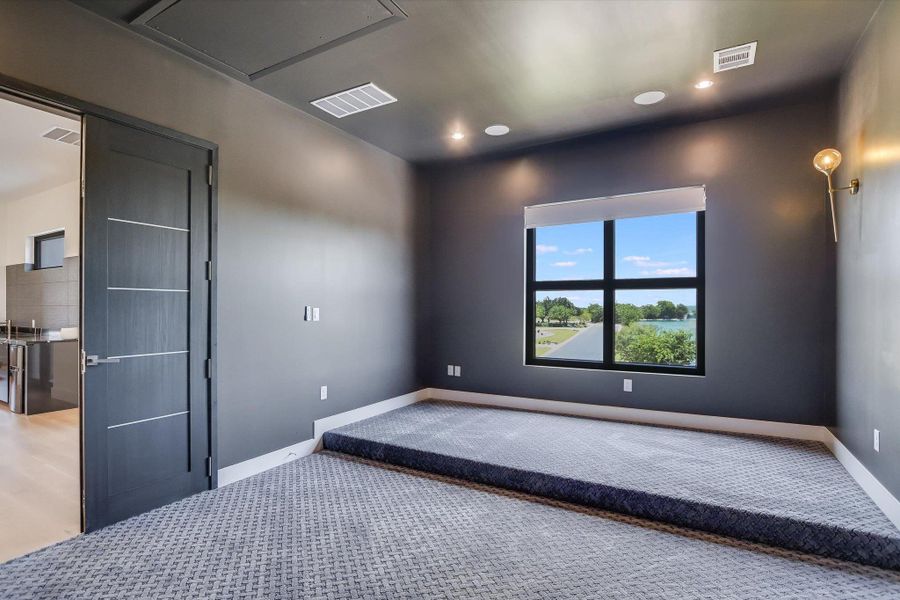 Media room featuring grey colored carpet and recessed lighting Media room featuring grey colored carpet and recessed lighting