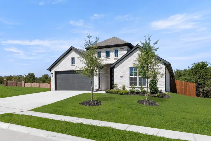 Front exterior of a new home in Waterford Park, Weatherford, TX, highlighting curb appeal (Image 2). Front exterior of a new home in Waterford Park, Weatherford, TX, highlighting curb appeal (Image 2).