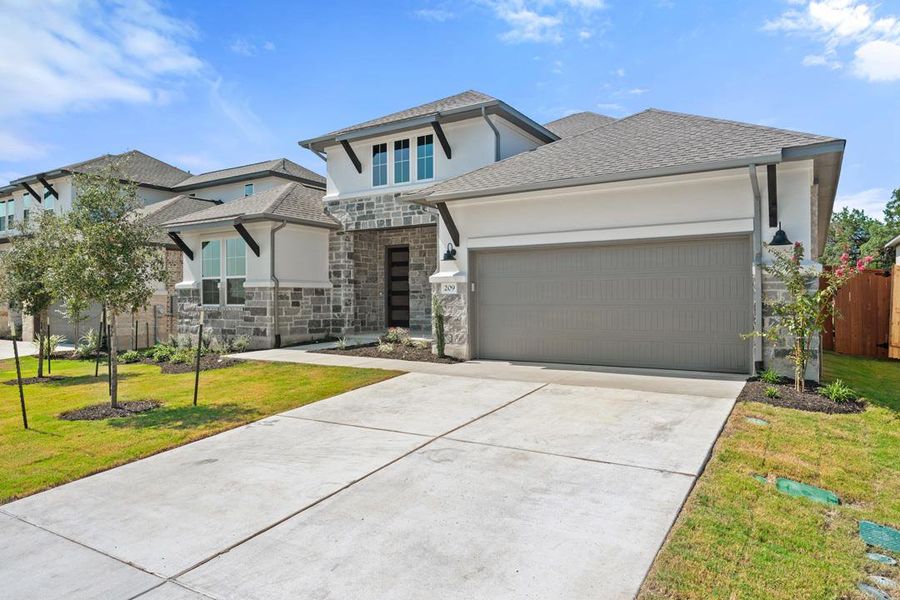 Front exterior of a new home in Capitol Collection at Lariat, Liberty Hill, TX, highlighting curb appeal (Image 24). Front exterior of a new home in Capitol Collection at Lariat, Liberty Hill, TX, highlighting curb appeal (Image 24).