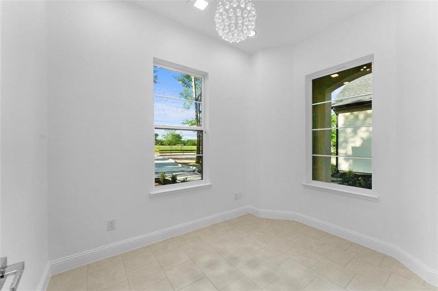 Unfurnished room with a chandelier and healthy amount of natural light Unfurnished room with a chandelier and healthy amount of natural light