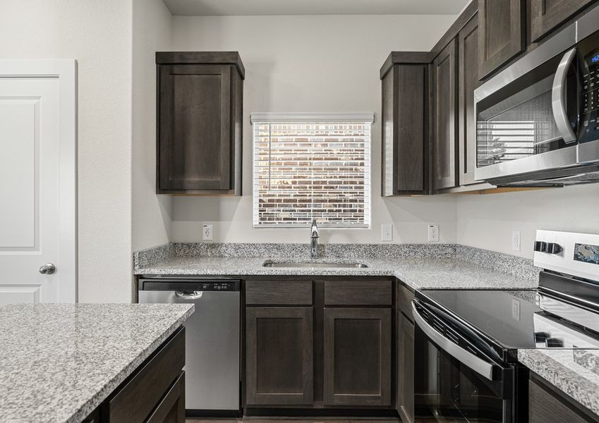 The kitchen has sprawling granite countertops.