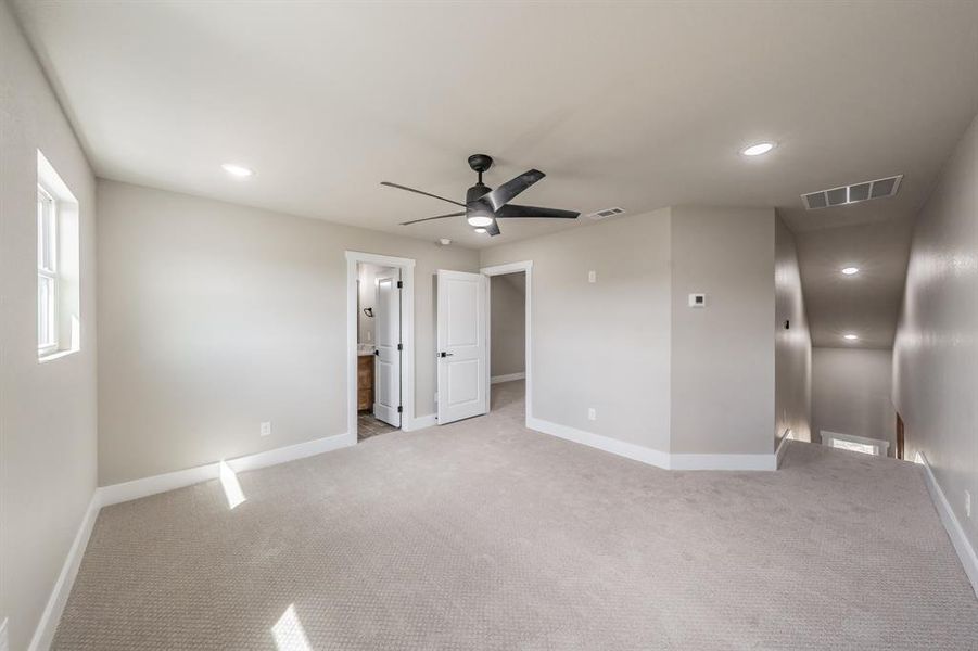 Unfurnished bedroom with carpet, recessed lighting, ensuite bathroom, and ceiling fan Unfurnished bedroom with carpet, recessed lighting, ensuite bathroom, and ceiling fan