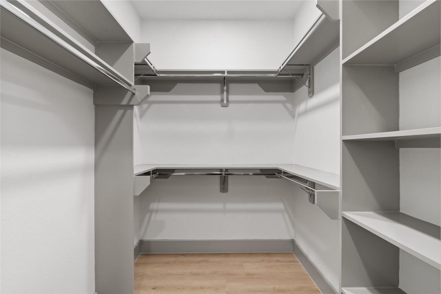 Maximize your mornings with this thoughtfully designed walk-in closet—featuring double hanging rods, built-in shelving, and ample space for everything from everyday essentials to seasonal favorites. Clean, organized, and ready for your routine. Maximize your mornings with this thoughtfully designed walk-in closet—featuring double hanging rods, built-in shelving, and ample space for everything from everyday essentials to seasonal favorites. Clean, organized, and ready for your routine.