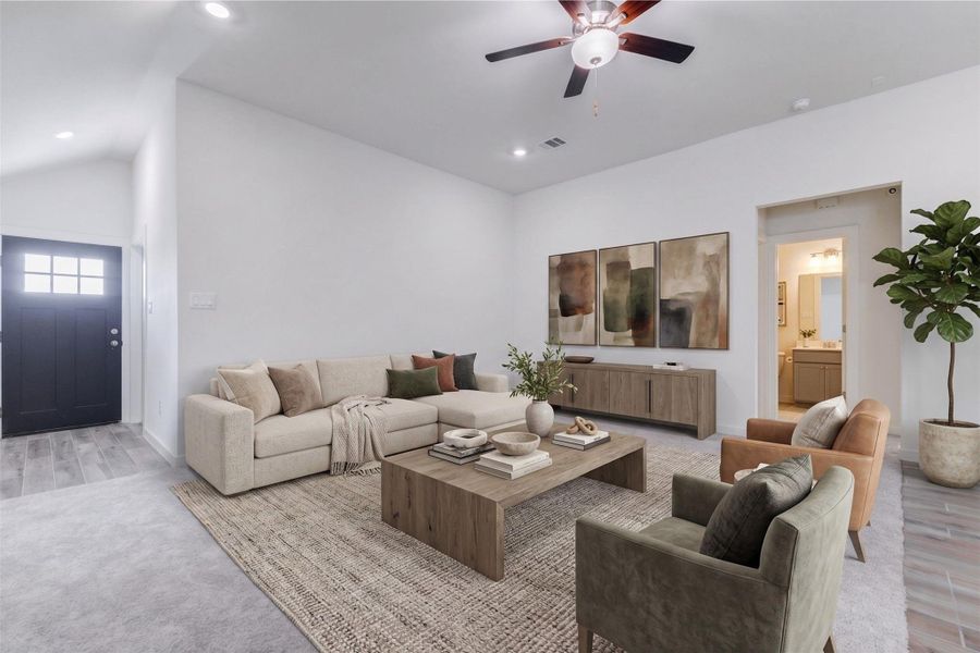 Large family room view with plush carpet, high ceilings, ceiling fan, recessed lighting, and sightlines to the entry and adjoining spaces. The neutral walls and open layout create a flexible blank canvas for comfortable seating, media, décor, and personal style. This photo has been virtually staged for visual reference.