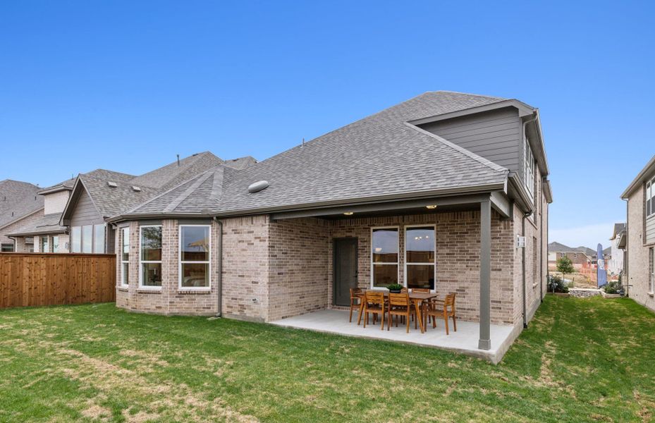 Fenced-in backyard with covered patio