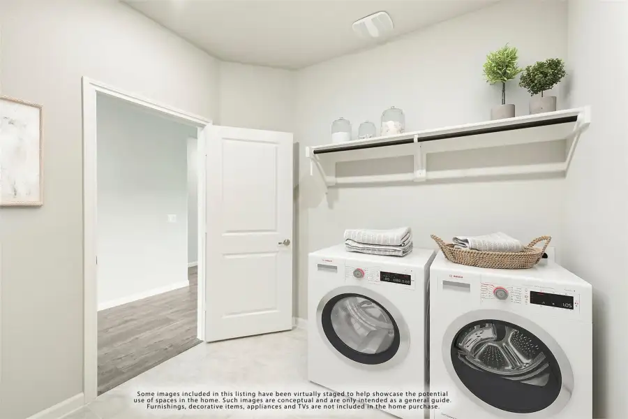 Laundry room with side-by-side washer and dryer, wall shelf, and hanging rod above the machines.