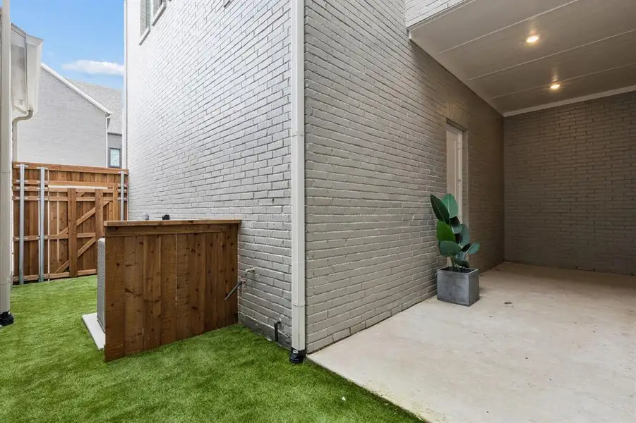 Exterior details and patio area of a home in Newman Village Townhomes, Frisco (Image 3). Exterior details and patio area of a home in Newman Village Townhomes, Frisco (Image 3).