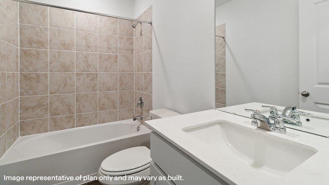 A well-appointed bathroom features a practical vanity and a tiled tub-shower combination. A well-appointed bathroom features a practical vanity and a tiled tub-shower combination.