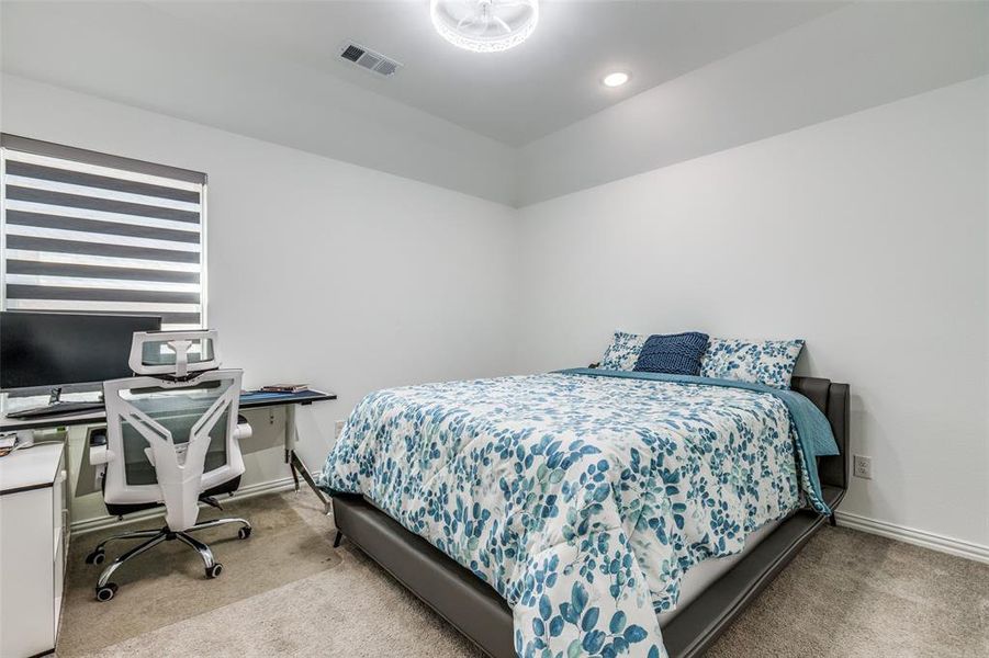 Spacious large second floor bedroom with luxury blinds and an ensuite bathroom featuring vaulted ceiling, carpeted flooring, and luxury light /fan and recessed lighting. Spacious large second floor bedroom with luxury blinds and an ensuite bathroom featuring vaulted ceiling, carpeted flooring, and luxury light /fan and recessed lighting.