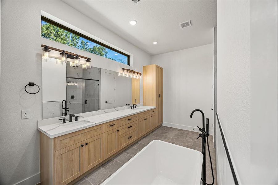 Large vanity area, double sinks, high ceilings, natural light, recessed lighting