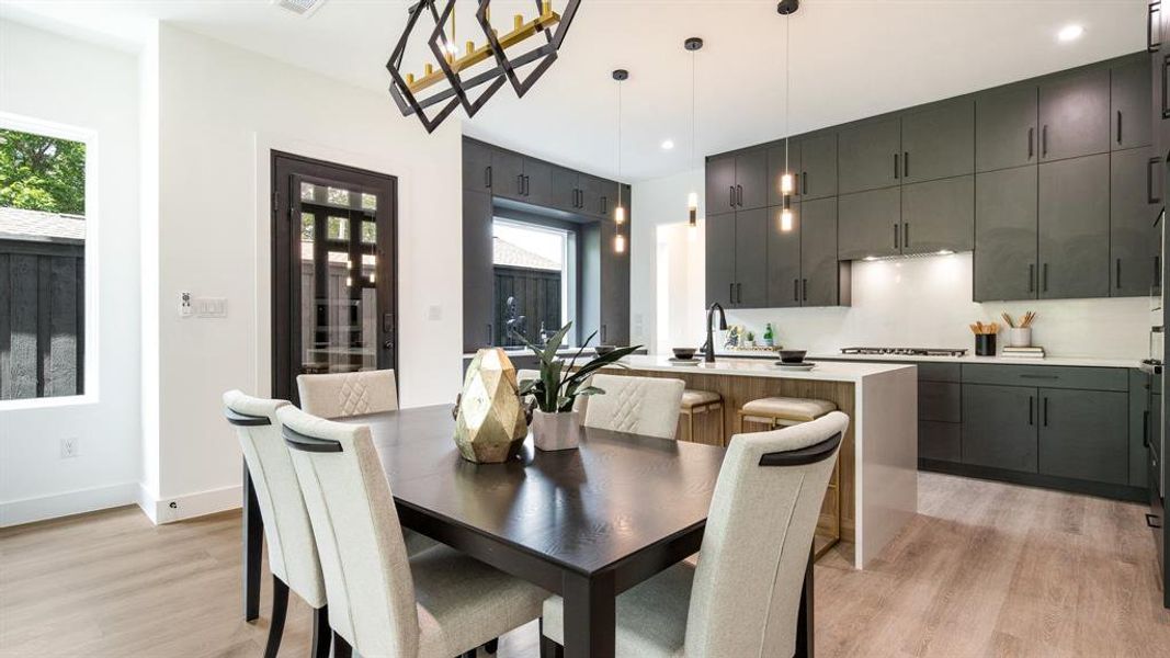 Dining space with sink and light wood-type flooring