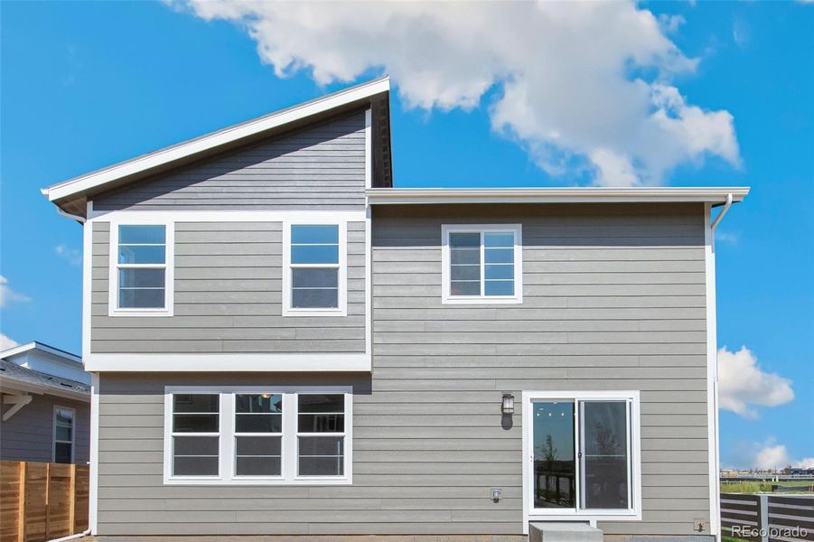 Front exterior of a new home in Legato, Commerce City, CO, highlighting curb appeal (Image 20).