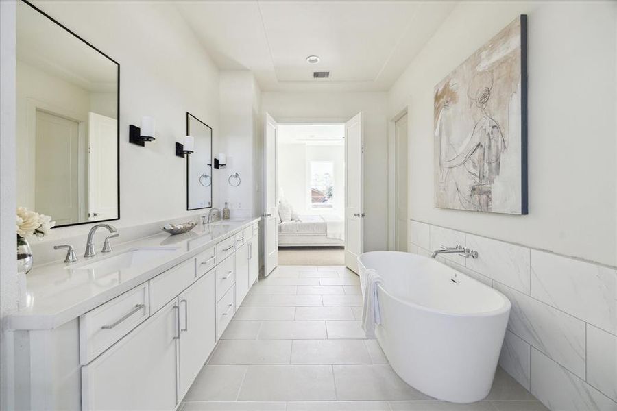 Spa Inspired Retreat – This primary bath features double vanities, quartz count tops, framed mirrors flanked by wall sconces adorned by a well-appointed bathroom chandelier.  Bring your night to a perfect close in the stand-alone soaking tub.