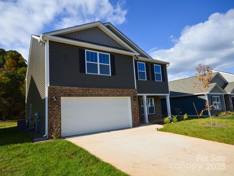 Front exterior of a new home in Wildbrook Village, Waynesville, NC, highlighting curb appeal (Image 1).