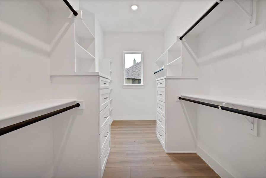 Spacious closet featuring light wood-type flooring Spacious closet featuring light wood-type flooring