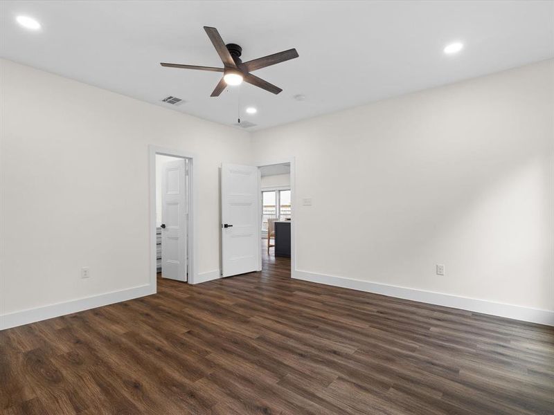 Unfurnished bedroom with dark wood-style flooring, ceiling fan, and recessed lighting