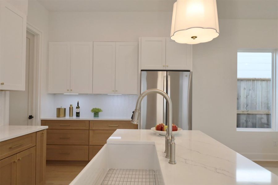 Bridge-style kitchen faucet with integrated pull-down spray head, combining classic charm with convenience.