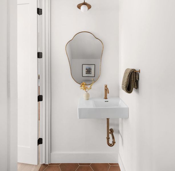 Bathroom view of a sink and baseboards