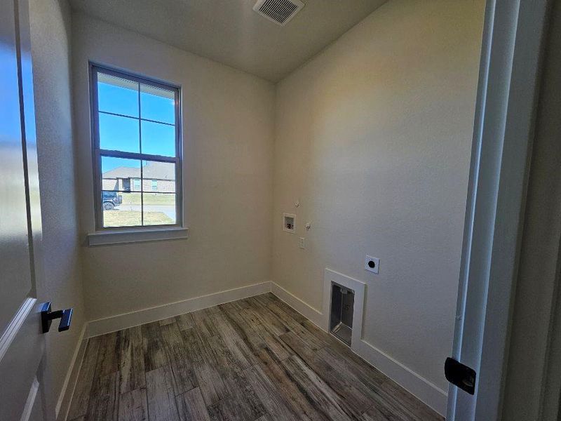 Laundry area featuring dark wood-type flooring, washer hookup, and electric dryer hookup