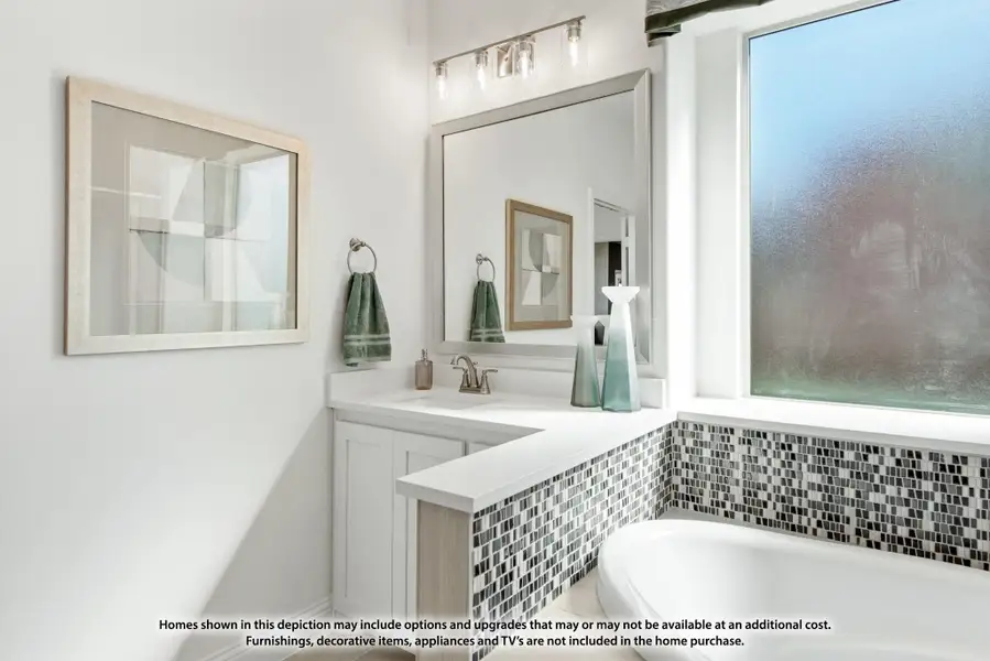 Bathroom with white vanity, large mirror, soaking tub with mosaic tile surround, and a large window Bathroom with white vanity, large mirror, soaking tub with mosaic tile surround, and a large window