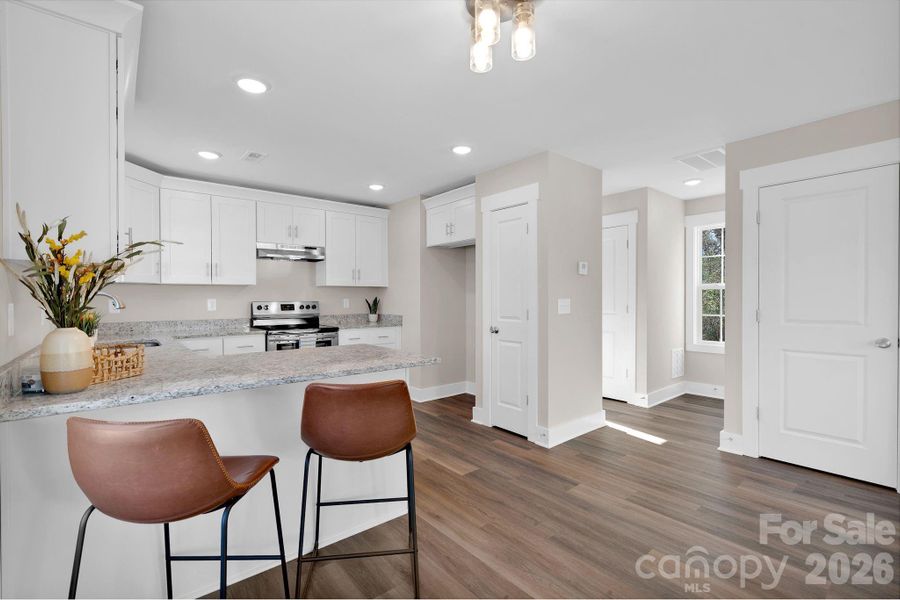 Breakfast bar offers extra seating for chatting with family and friends while preparing meals together.