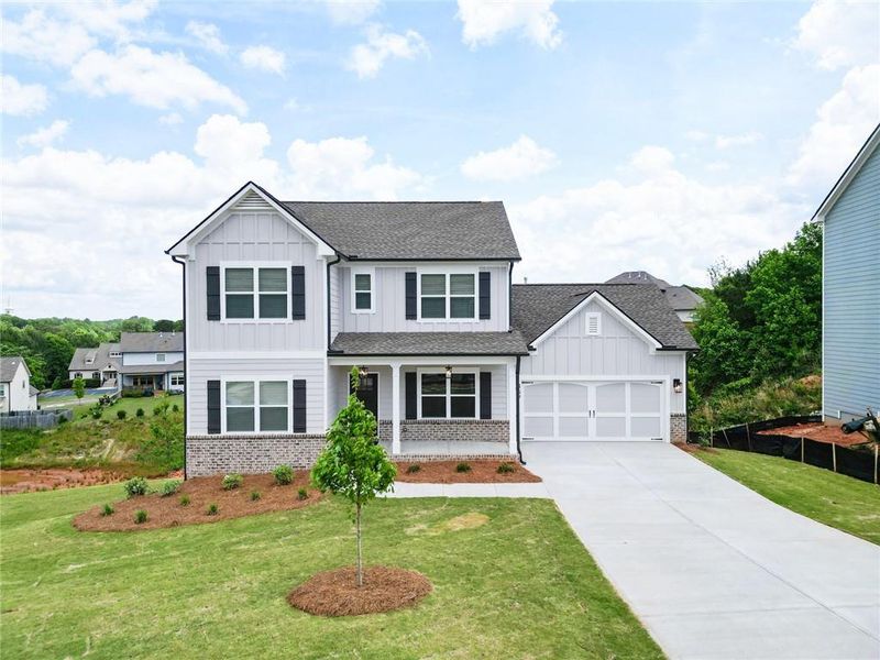Front exterior of a new home in Calgary Downs, Winder, GA, highlighting curb appeal (Image 1).