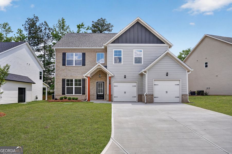 Front exterior of a new home in The Fairways at Mirror Lake, Villa Rica, GA, highlighting curb appeal (Image 19). Front exterior of a new home in The Fairways at Mirror Lake, Villa Rica, GA, highlighting curb appeal (Image 19).