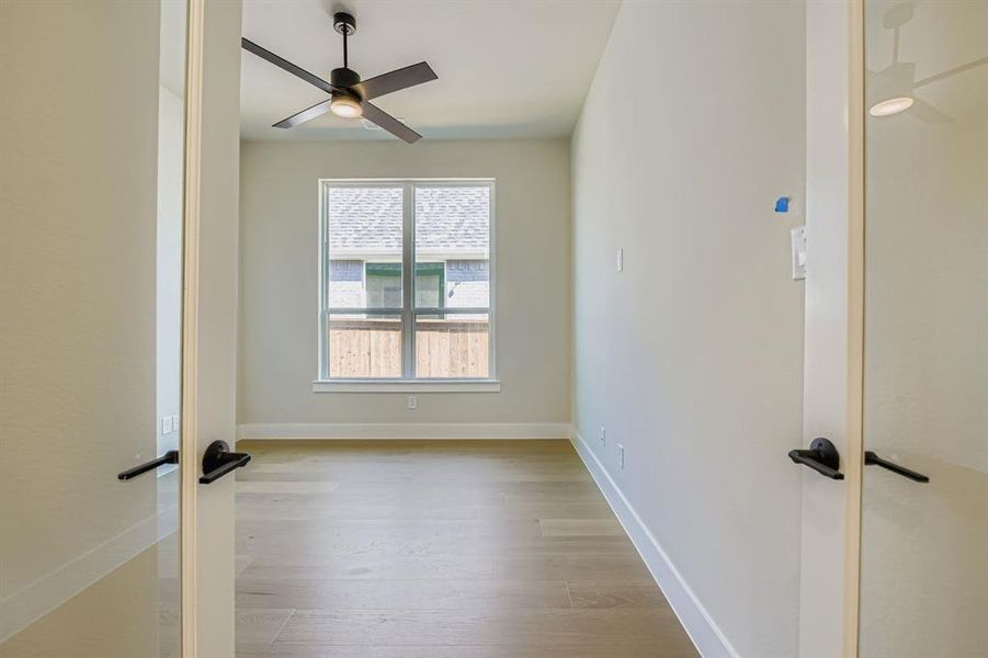 Spare room featuring light wood-style flooring and a ceiling fan