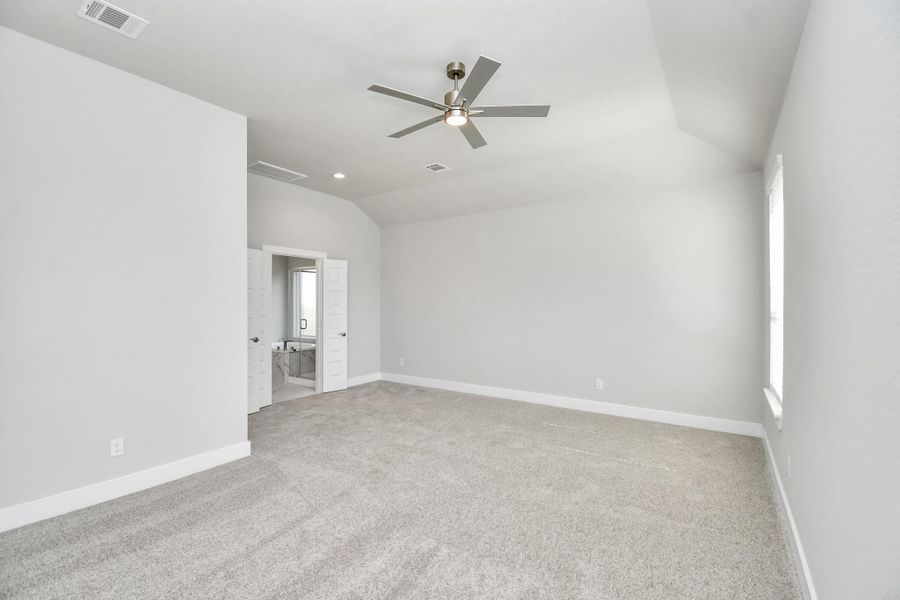 Come and unwind after a long day in this magnificent primary suite! This spacious room features plush carpet, warm paint, high ceilings and large windows with privacy blinds. Sample photo of completed home with similar floor plan. Actual colors and selections may vary.