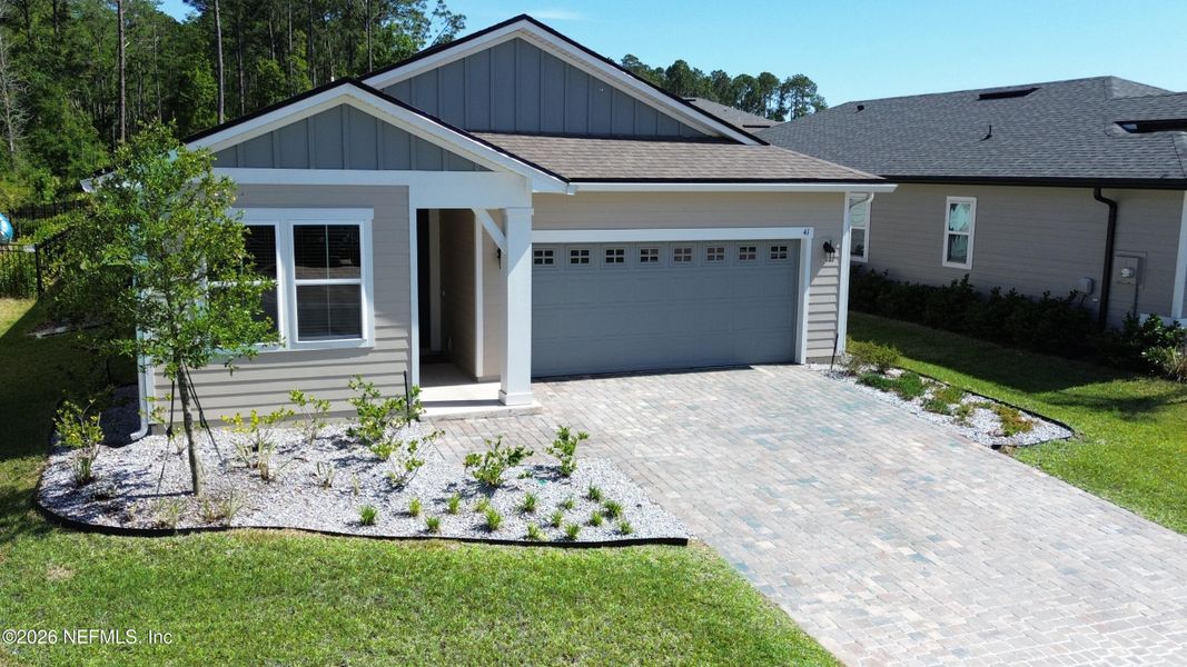 Front exterior of a new home in Seasons at TrailMark, St. Augustine, FL, highlighting curb appeal (Image 34).