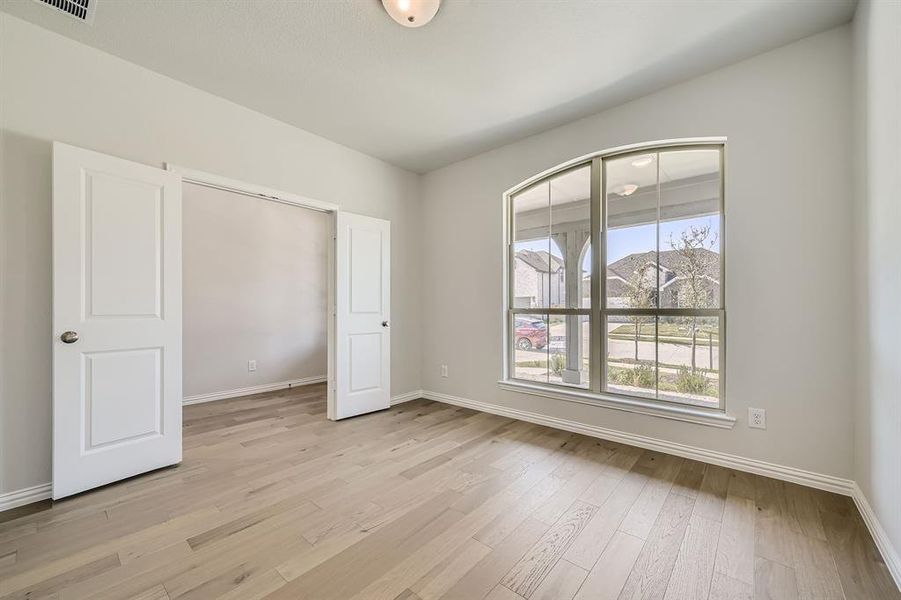 Unfurnished bedroom featuring light hardwood / wood-style floors