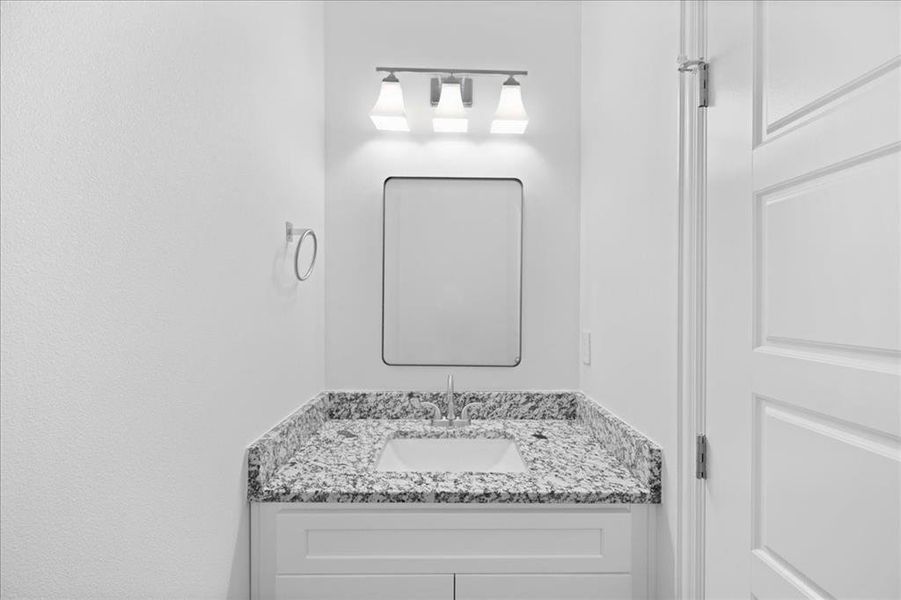 Convenient half bath with modern fixtures and clean, bright finishes—perfect for guests.