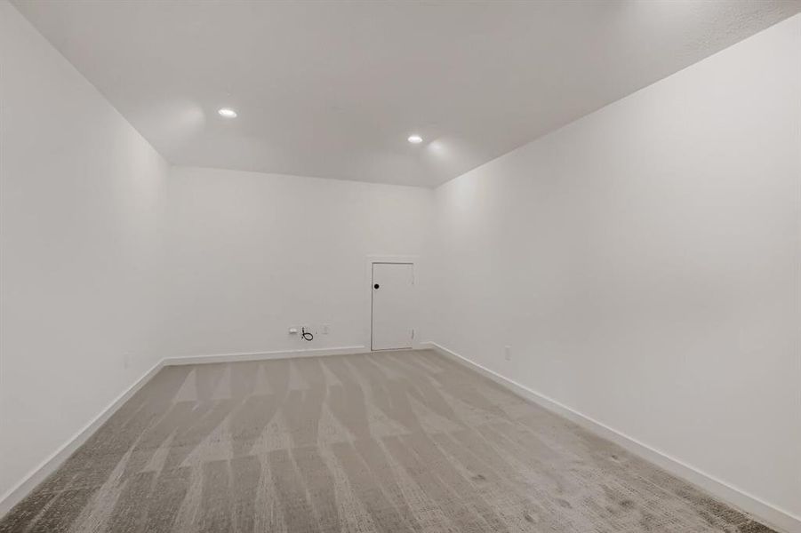 Laundry area with light carpet and recessed lighting