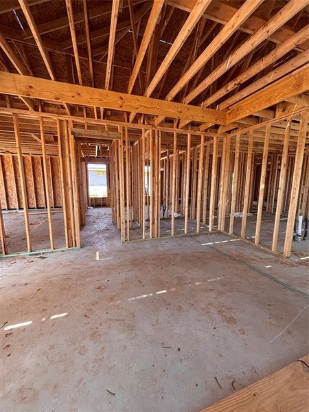 New construction framing showcasing structural wood beams and an open concept layout