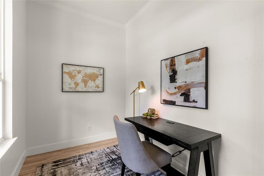 Home office featuring ornamental molding, wood finished floors, and baseboards Home office featuring ornamental molding, wood finished floors, and baseboards