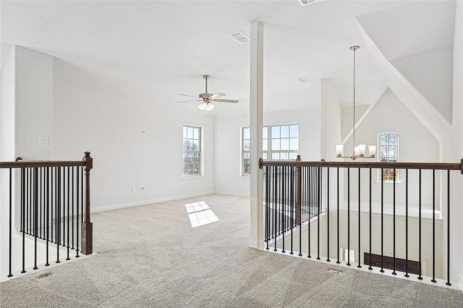 Hall featuring carpet flooring and an upstairs landing