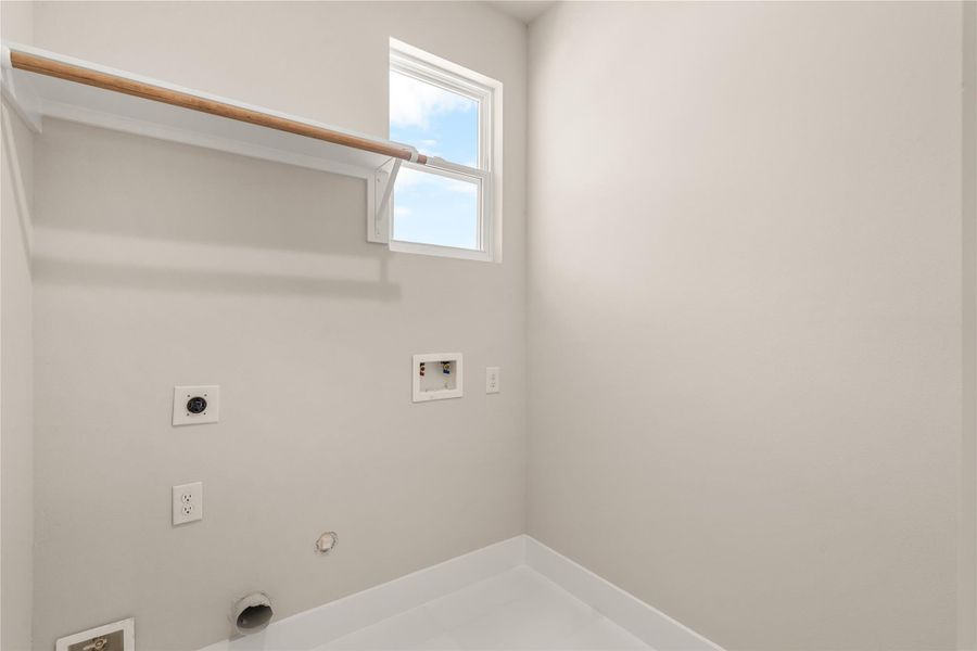 Dedicated laundry room with utility connections and built in shelving for hanging the delicate garments.