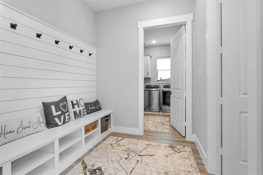 Enormous mud room with hangers and storage, and half bath come in handy when coming in from the 4-car garage.