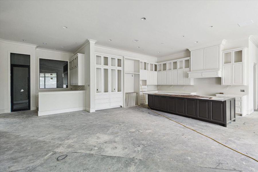 Progress photo from December 2025 - Kitchen with adjacent wet bar and climate-controlled wine room