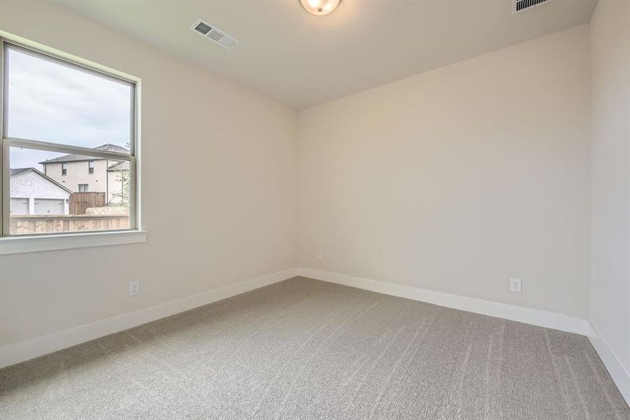 Carpeted empty room featuring baseboards Carpeted empty room featuring baseboards